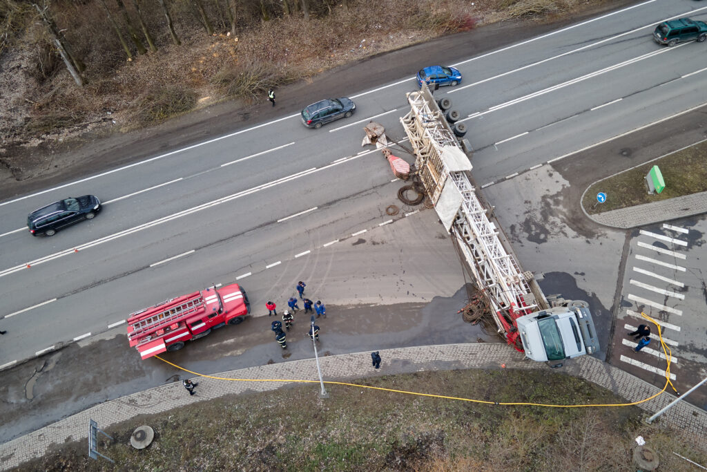 Aerial view of road accident with overturned truck blocking traffic