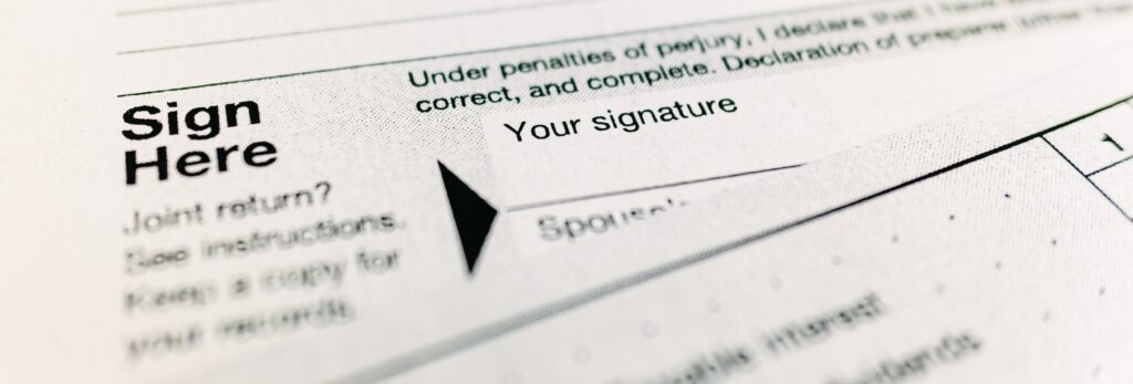 Sign here text on a government tax form.